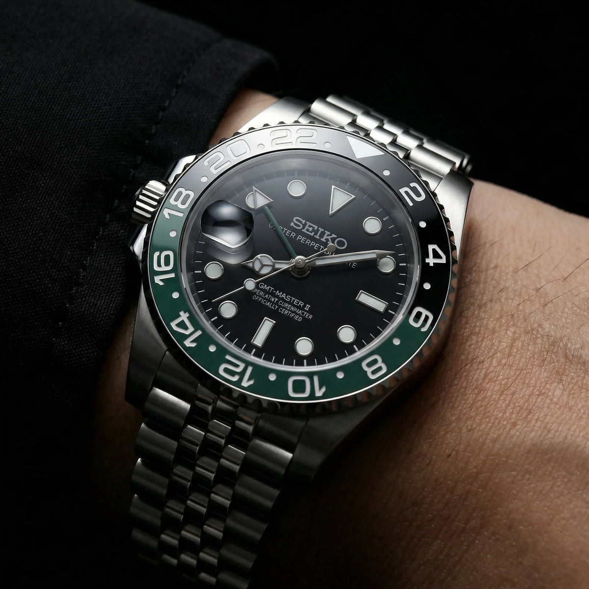Green and black custom GMT watch on the wrist
